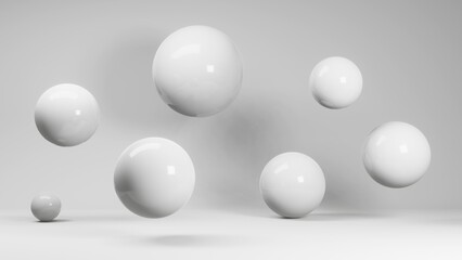 White spheres hang in weightlessness and stand on the floor. White uniform background.