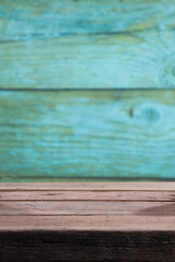 Empty wooden table. Blur blue background behind old wooden table. For product positioning for beverage and food