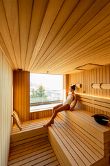 Young woman relaxing in the sauna