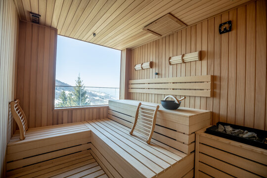 Empty wooden sauna room with traditional sauna accessories