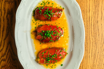 Stuffed pepper with sauce on a white plate