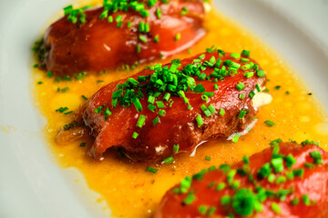 Stuffed pepper with sauce on a white plate