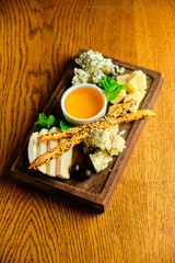 rye bruschetta with honey pumpkin and goat cheese on a dark wood background. tinting. selective focus on mint on the front bruschetta
