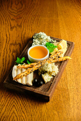 rye bruschetta with honey pumpkin and goat cheese on a dark wood background. tinting. selective focus on mint on the front bruschetta