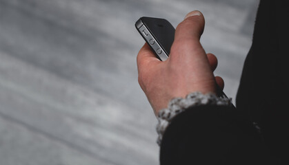 Male hands close-up. A man holds a phone in his hands