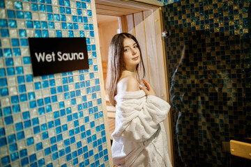 Beauty, spa, healthy lifestyle concept. Beautiful young girl relaxing at luxury spa in wet sauna