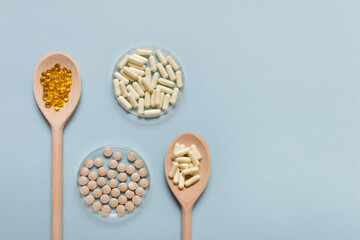 Medical composition with health supplements on wooden spoons and Petri dishes