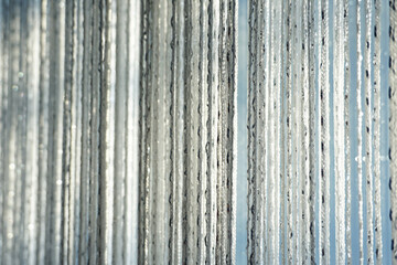 Close up look of a window curtain made with silver tinsel thread