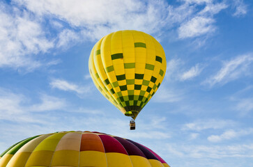 Colorful hot air balloon flying over blue sky