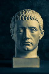 Bronze color gypsum copy of ancient statue of Germanicus Julius Caesar head for artists on black...