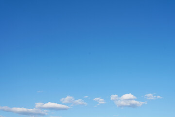 Naklejka na ściany i meble Summer blue sky background with small clouds. copy space
