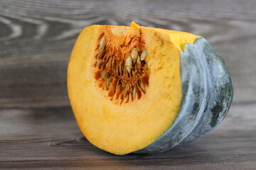 Sliced pumpkin. Shot on rustic wooden background