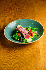 Sliced steak with blood. on a blue plate