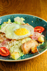 Caesar salad with large fried eggs