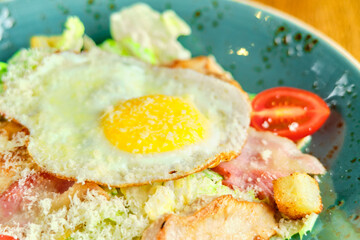 Caesar salad with large fried eggs