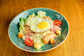 Caesar salad with large fried eggs