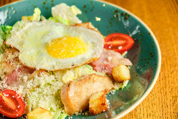 Caesar salad with large fried eggs