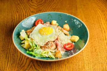 Caesar salad with large fried eggs