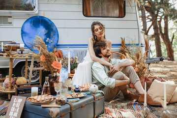 a young couple travels in a camper. enjoy each other and rest in a motorhome. love in motorhomes