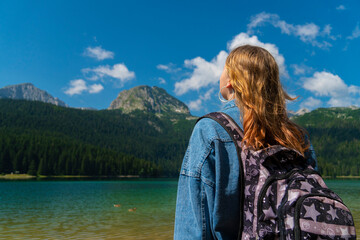 Naklejka premium Montenegro. Zabljak. Durmitor National Park. Popular tourist spot. The girl enjoys a beautiful view. Beauty of nature concept background