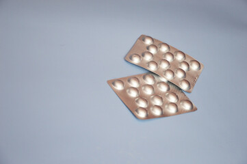 Silver blisters, pill packs for treatment and hospitals, pharmacies. Free space for text. Medicine, drug production.