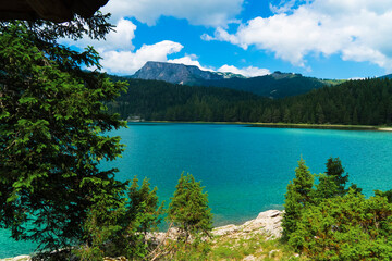 Montenegro. Zabljak. Durmitor National Park. Popular tourist spot. Black lake surrounded by green coniferous forest. Beauty of nature concept background