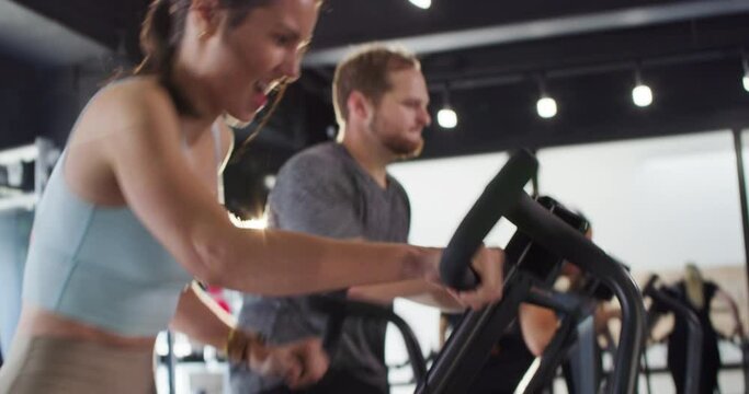 Energetic athletes train on spin bikes in a gym