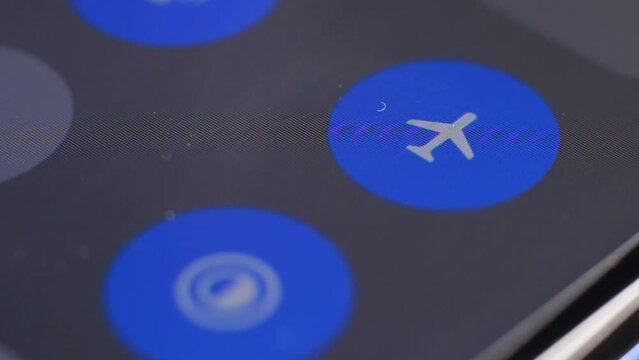 Macro close up of airplane mode button pressed on a LCD display
