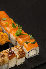 Japanese sushi rolls on a black background macro