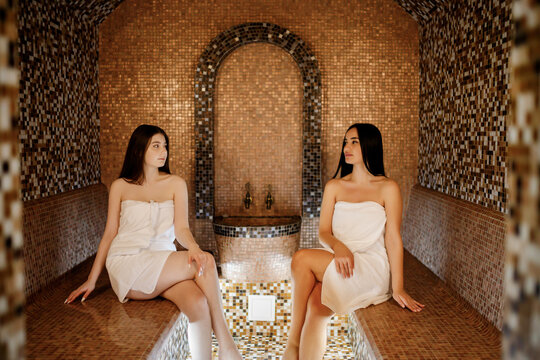 Beauty, spa, healthy lifestyle concept. Beautiful young girls relaxing at luxury turkish spa with hammam sauna