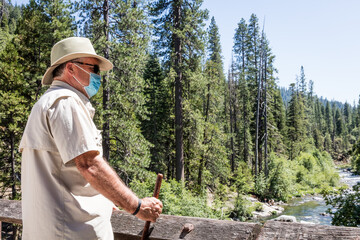 Person with mask hiking in woods