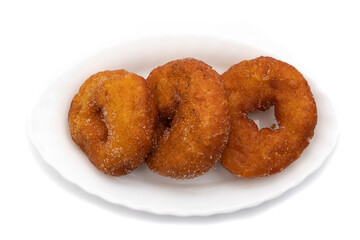 Three Spanish Donuts(Rosquillas) on a white plate, isolated on white background. The donut is a typical Spanish Easter sweet, whose origin dates back to the ancient Roman Empire.