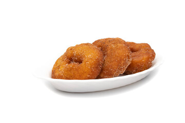 Three Spanish Donuts(Rosquillas) on a white plate, isolated on white background. The donut is a typical Spanish Easter sweet, whose origin dates back to the ancient Roman Empire.