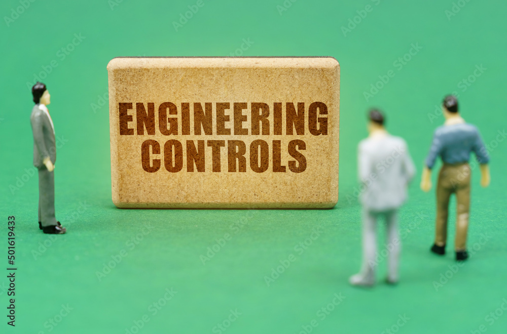 Poster on the green surface are figures of people and a sign with the inscription - engineering controls