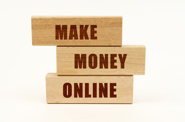 On a white surface are wooden blocks with the inscription - MAKE MONEY ONLINE