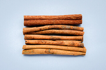 Raw cinnamon sticks on a gray background
