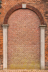 Red brick wall fragment with arch shape