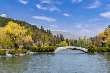Fototapeta na wymiar Small bridge cross over the small lake in Dilijan city park