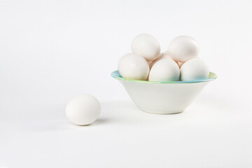 Plate with chicken eggs on a white background.Copy space.