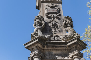 Stone statue of Jan van Werth (1884) on a gothic column. The seated figures on north and south side represent valor and purity of city of Cologne. Alte Markt, Cologne, North Rhine Westphalia, Germany.
