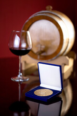 victory medal in a gift box on the background of a glass of wine