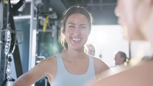 Happy woman talks with group of women after an exercise class at a cross training gym - Powered by Adobe
