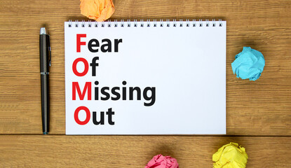 FOMO fear of missing out symbol. Concept words FOMO fear of missing out on the note on a beautiful white background. Business FOMO fear of missing out concept. Copy space.