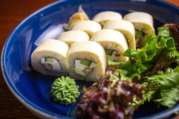 rolls with cream cheese on a blue plate. salad on a plate
