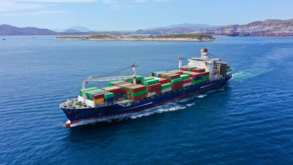 Aerial drone photo of colourful truck size container ship cruising in deep blue Mediterranean sea