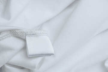 Blank label for composition and description of fabric on a background of white clothing texture....