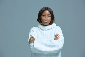 Serious focused disgruntled young african american woman arms crossed staring at camera, show...