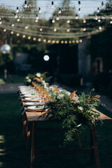 rectangular wedding festive set table in the patio, garden in nature