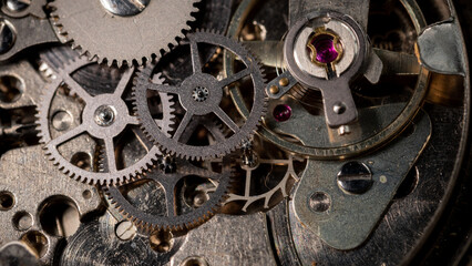 Clockwork, hand wind up watch mechanism - close up macro, showing mechanical movements - gears, ruby jewels and mainspring
