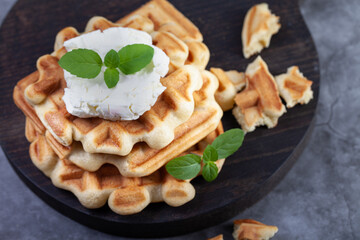 Homemade freshly baked belgian waffles with mint leaves on dark background. - 501632424